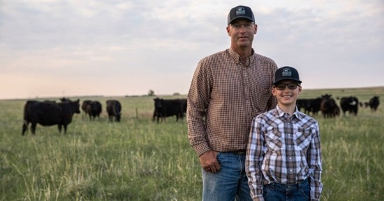 Nebraska producer Troy Anderson (left) stands with his son in a pasture on their operation, where Beef Quality Assurance principles guide daily decisions around herd health, handling and overall cattle care. Image courtesy of Certified Angus Beef.