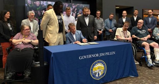 Gov. Pillen signs LB 1091, with Sen. Bostar and QLI CEO Nash Mahupete