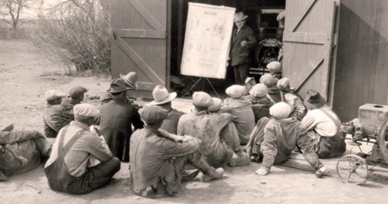  An Extension agent meets with a group of rural Nebraskans, discussing how an ignition engine works, in this undated photo. (University Archives and Special Collections)