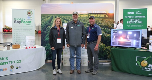 Nebraska State Fire School 1: Maria and Dave Garlie of Cross Plains Solutions with United Soybean Board Director Greg Greving (middle) at the Nebraska State Fire School expo in Grand Island.